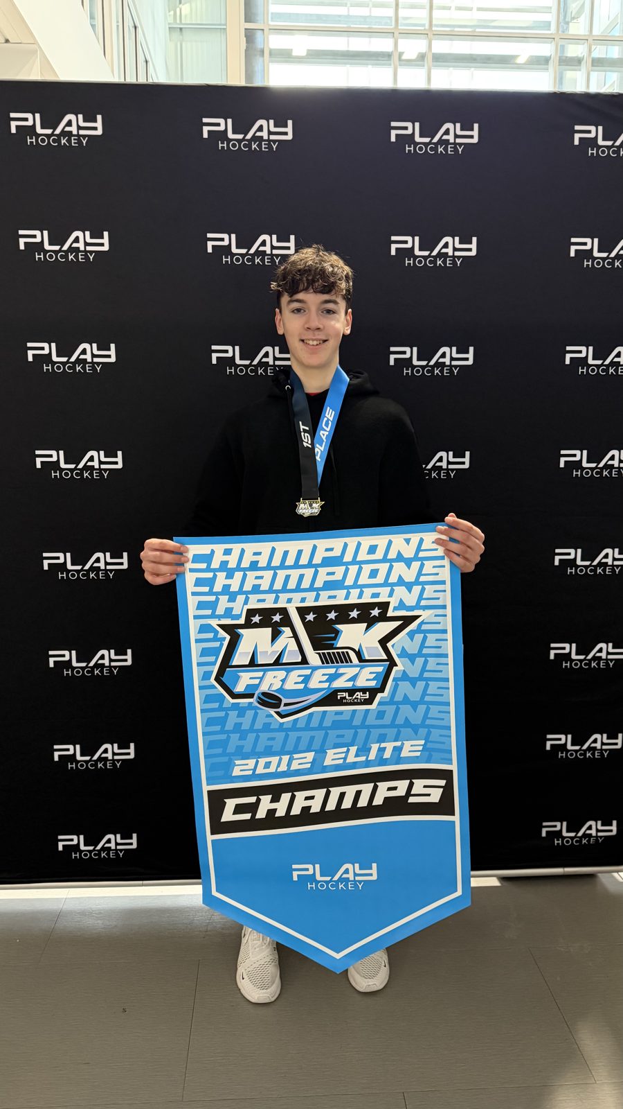 Eamonn Zaouk with the MLK Freeze champions banner